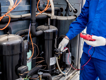 HVAC technician providing HVAC maintenance services